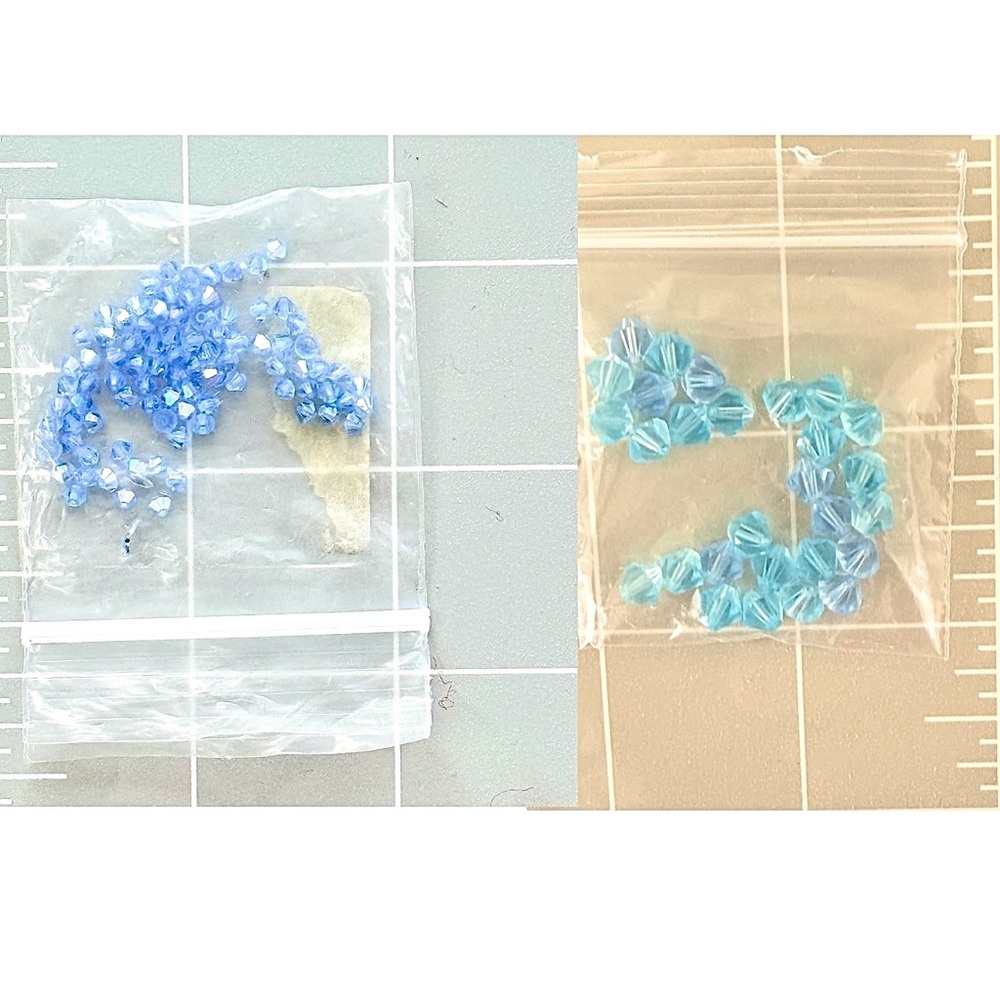 Two packets of blue crystal beads.